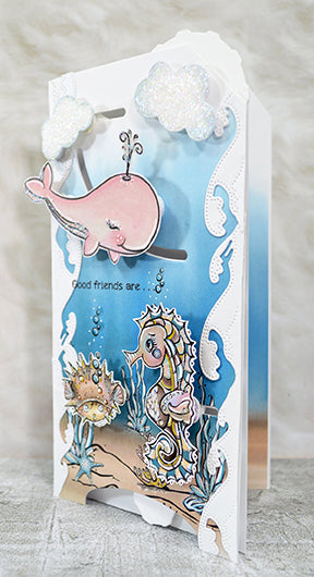 This TLC Designs slimline card uses both interactive dies. The Double Dial Die from TLC Designs on the top with the Aztec Sunshine Circle embellishment cloud die. The bottom is using the See You In The Center interactive die. Illustrations from Fancy Fins digital stamp and the Seahorse Samm precolored digital images.