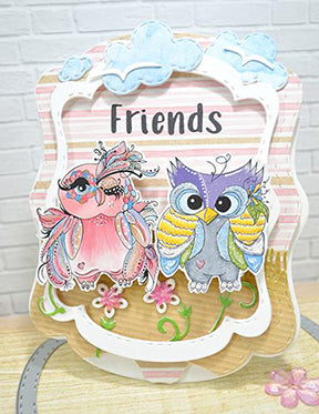 Winking Wanda and the Gazing Gabe digital images are Friends meeting up in the middle of this greeting card project with the help of the See You in the Center interactive die and the clouds and scenery dies from the Aztec Sunshine die. All available at TLCDesigns.shop