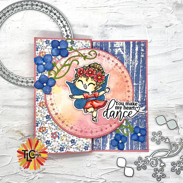 The Exclusive Tiptoe Fairy Dance stamps combined with beautiful and delicate flower petal dies from TLC Designs has helped DT Melanie design this special fold card with the blooming Medley papers!