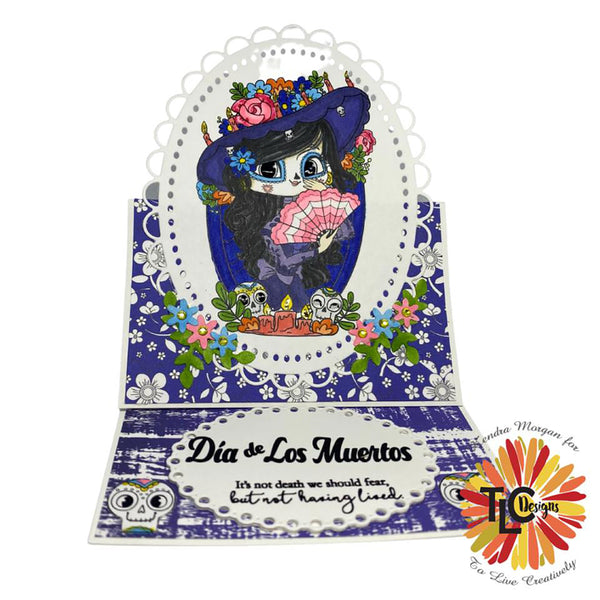 LaCatrina propped up to memorialize the Day of the dead featured easel card!  The Blooming Medley papers are a perfect fit and the embellishment dies from the Aviary Oval Die!