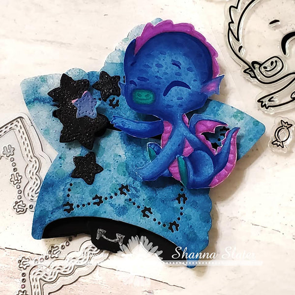 The star Spangled Confetti Die cut is a perfect size card project!  In blues of watercolor, Sweetie the Dragon is perched to reach the stars!  Products from TLCDesigns.shop. 