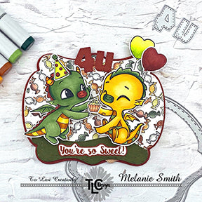 Designer Melanie has outdone herself with this interactive die cut project! The two sweetest green and yellow colored Dragon Baby images moving toward the cupcake in the center on a project 4U~ There are balloons and the corrdinating designer papers in the background from the Dragons in Autumn Digital Paper Pack! All products of TLCDesigns.shop