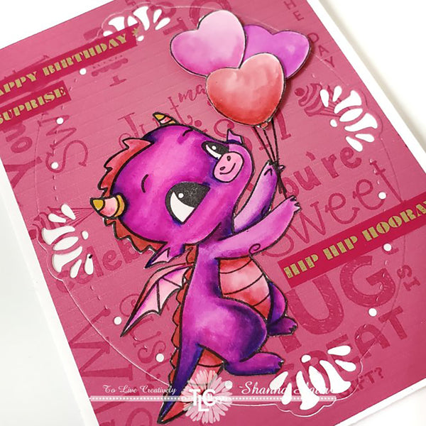 Happy the Dragon stamp is in purples and pinks on this DIY background designed greeting card project with the Oval Lily die cut frame from TLCDesigns.shop