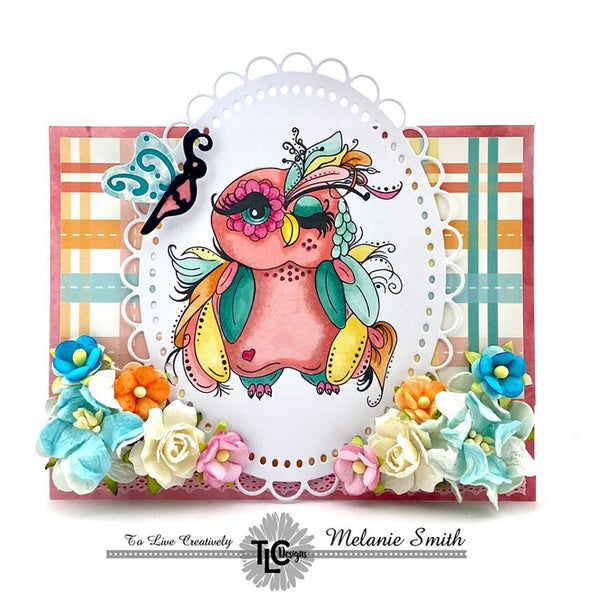 Winking Wanda, the sassy and classy digital owl illustration from TLCDesigns.shop is centered as a focal point on the colorful little greeting card1  Visited by the futterfly die cut and the Oval die frame.  She's just a delight!  Come see!