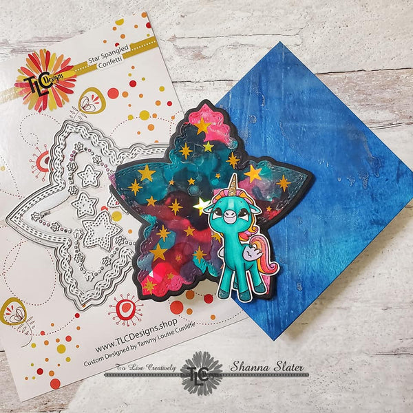 Shanna from TLCDesigns has created a cute star shaped multicolored greeting card witht he star spangled confetti die and the Alicorn happiness illustration