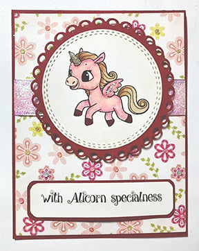 This greeting card in floral pink paper backdrop is with Alicorn specialness like the sentiment says! The doily circle in the center is highlighted with a stamped image from the TLCDesigns.shop Alicorn Happiness stamp set